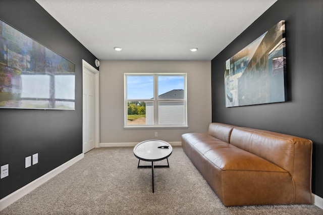 living area with carpet, baseboards, a textured ceiling, and recessed lighting