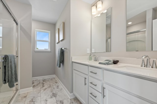 bathroom featuring marble look tiles, a shower stall, baseboards, and double vanity