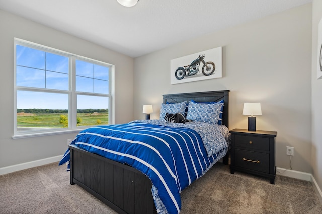 bedroom featuring carpet floors and baseboards