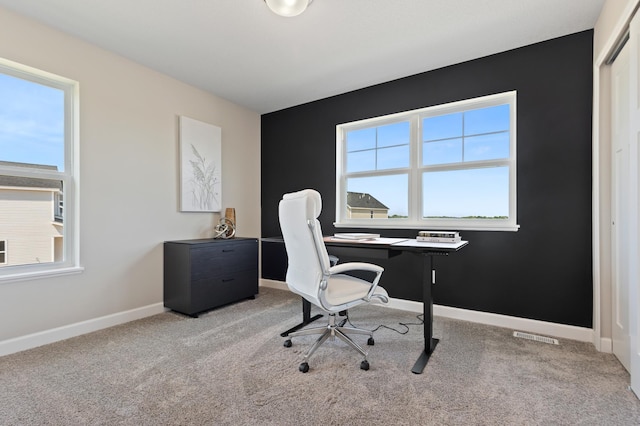 carpeted home office featuring baseboards