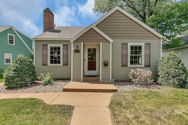 1317 8th Ave N, Saint Cloud, MN 56303 - bungalow with a front yard and a chimney