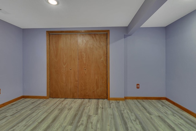 1317 8th Ave N, Saint Cloud, MN 56303 - unfurnished bedroom with baseboards, light wood-style floors, and a closet