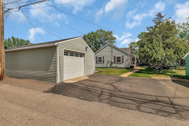 1317 8th Ave N, Saint Cloud, MN 56303 - view of front facade with an outdoor structure, a garage, driveway, and a front lawn
