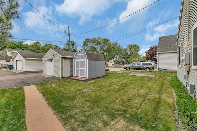 1317 8th Ave N, Saint Cloud, MN 56303 - view of green lawn with an outbuilding, a garage, and a shed