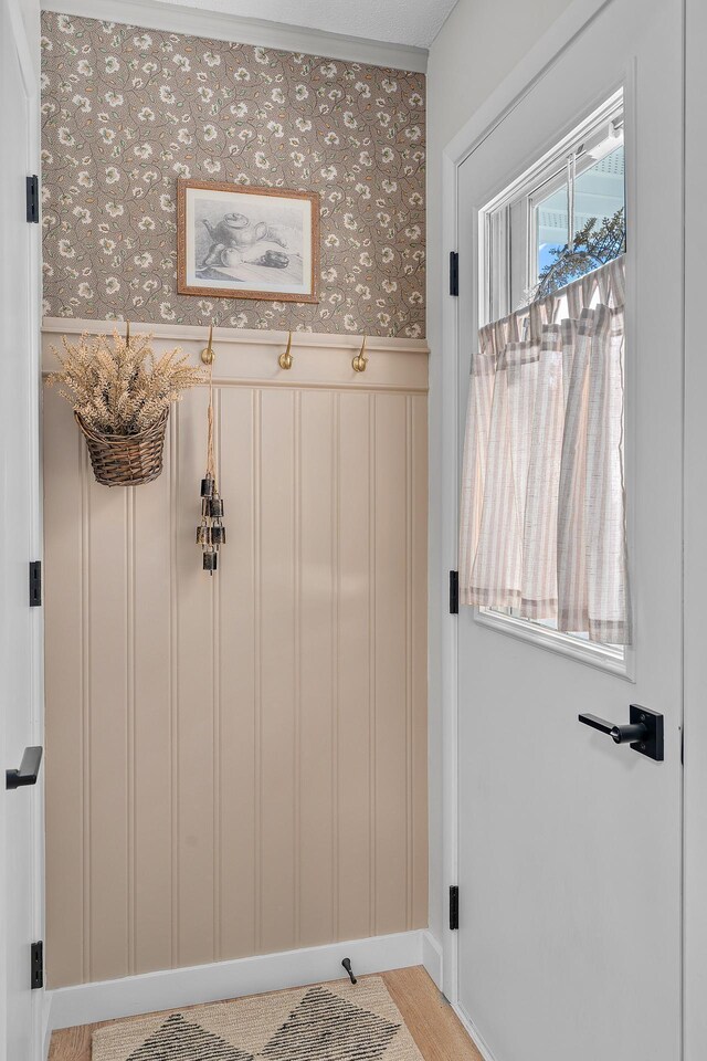 816 5th St S, Stillwater, MN 55082 - mudroom with a wainscoted wall, wallpapered walls, a decorative wall, and baseboards