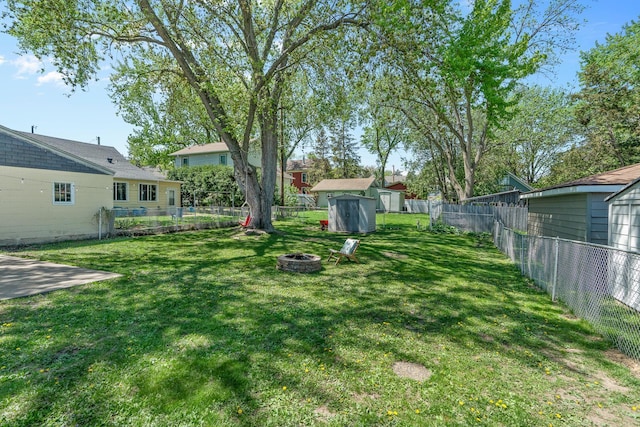 816 5th St S, Stillwater, MN 55082 - view of yard with an outdoor fire pit, a storage unit, and an outdoor structure