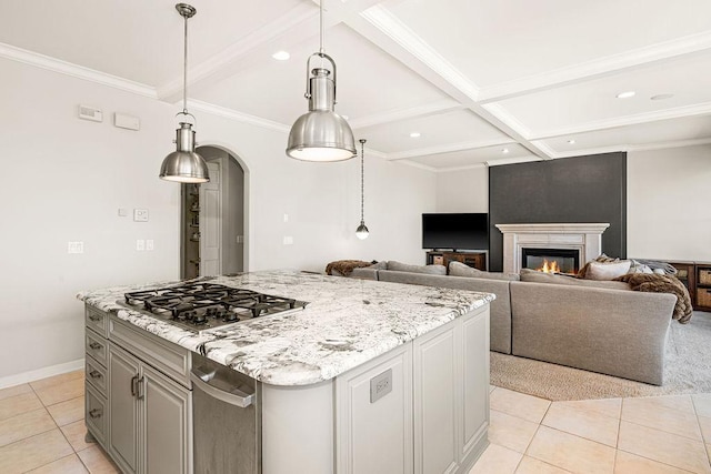 kitchen featuring stainless steel gas stovetop, arched walkways, beam ceiling, light tile patterned floors, and a glass covered fireplace