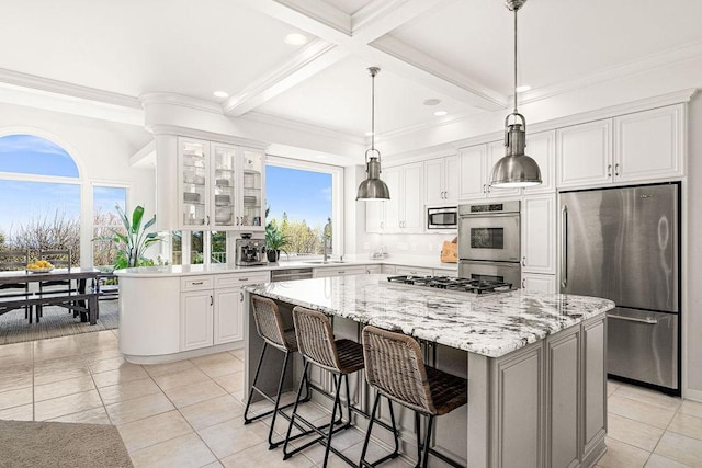 kitchen with stainless steel appliances, a kitchen island, white cabinetry, beamed ceiling, and recessed lighting