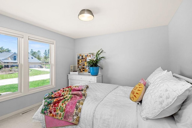 carpeted bedroom with baseboards