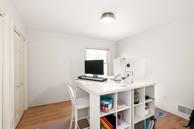 home office featuring light wood-style floors and baseboards