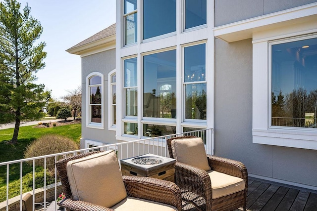 wooden terrace featuring a fire pit