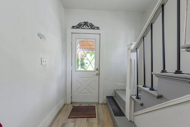 entryway with light wood-style floors and baseboards