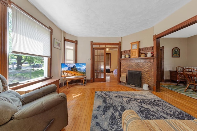 living area with a fireplace and hardwood / wood-style flooring