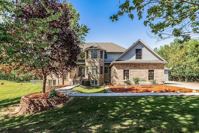 view of front facade featuring a front yard and brick siding