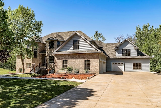 view of front of house with concrete driveway, brick siding, a front yard, a garage, and a shingled roof