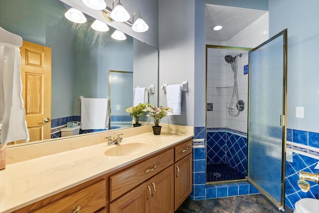 full bath with a shower stall and vanity