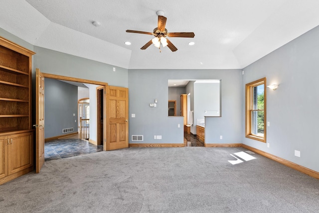 unfurnished bedroom featuring baseboards, carpet flooring, vaulted ceiling, ensuite bath, and recessed lighting