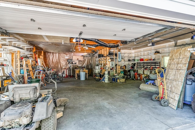 garage with a workshop area and a garage door opener