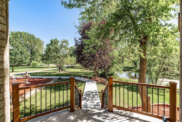 deck featuring a lawn and a water view