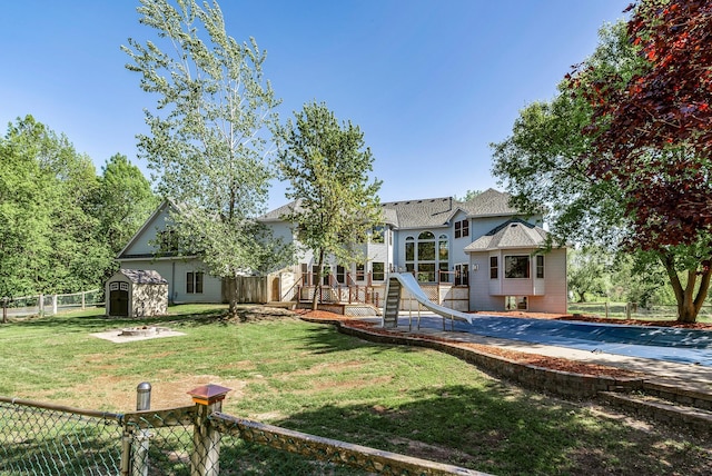 back of property with a storage unit, an outbuilding, and a patio