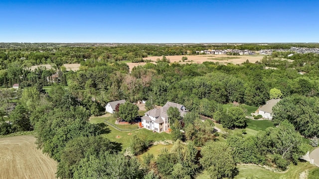 view of property location with a forest