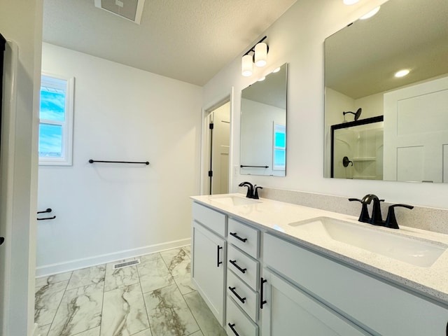 11367 84th St NE, Otsego, MN 55330 - bathroom with marble look tiles, double vanity, baseboards, a shower, and recessed lighting