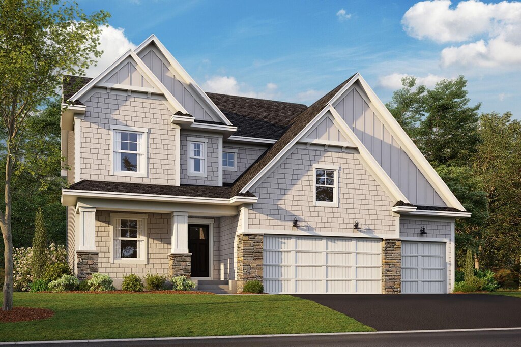 craftsman-style house with board and batten siding, stone siding, a front lawn, an attached garage, and driveway