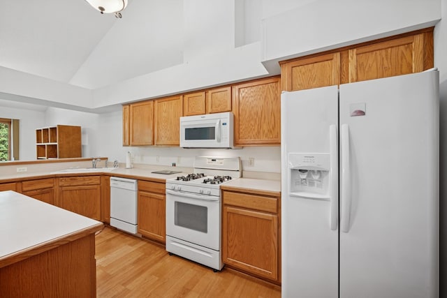217 Canyon Dr, Hudson, WI 54016 - kitchen with white appliances, light wood-type flooring, light countertops, brown cabinetry, and high vaulted ceiling