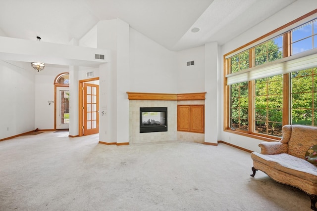 217 Canyon Dr, Hudson, WI 54016 - carpeted living room with high vaulted ceiling and a tile fireplace