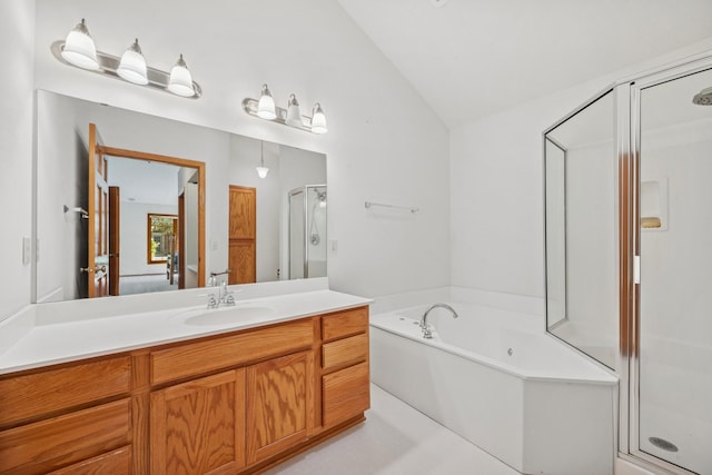 217 Canyon Dr, Hudson, WI 54016 - ensuite bathroom featuring vaulted ceiling, a stall shower, vanity, and a bath