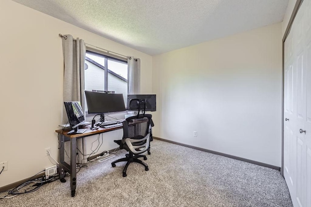 office featuring carpet flooring, a textured ceiling, and baseboards