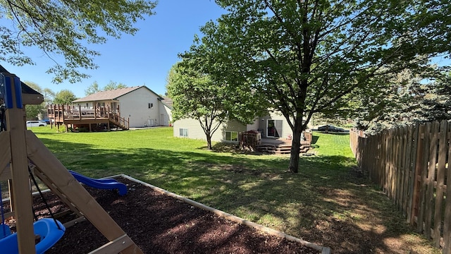 view of yard featuring a deck and a playground