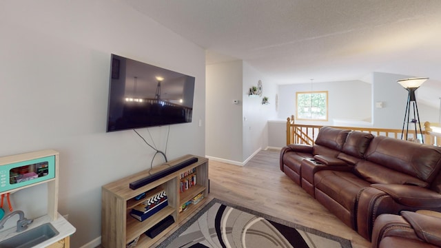 living area with wood finished floors and baseboards