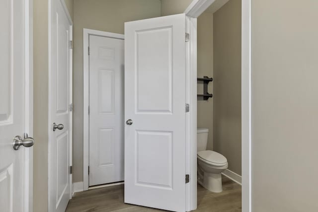 16386 Jaffna Pl, Lakeville, MN 55044 - bathroom featuring wood finished floors, toilet, and baseboards