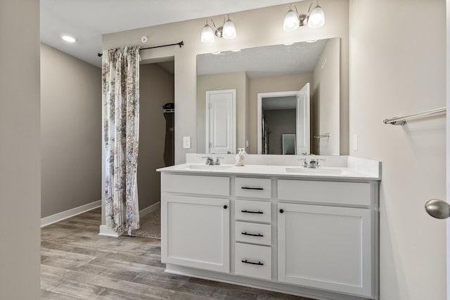 16386 Jaffna Pl, Lakeville, MN 55044 - full bathroom featuring double vanity, wood finished floors, and baseboards
