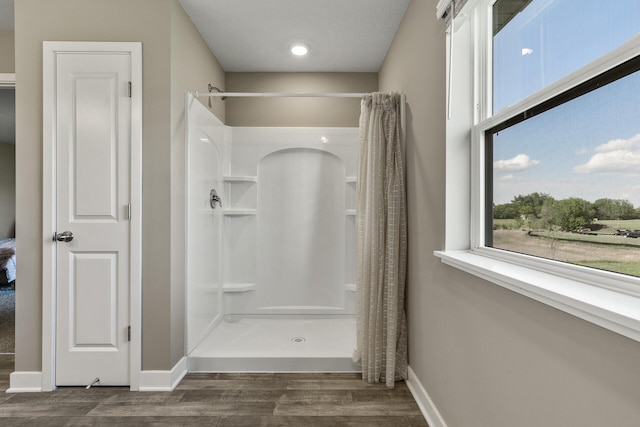 16386 Jaffna Pl, Lakeville, MN 55044 - bathroom with a shower stall, healthy amount of natural light, and wood finished floors