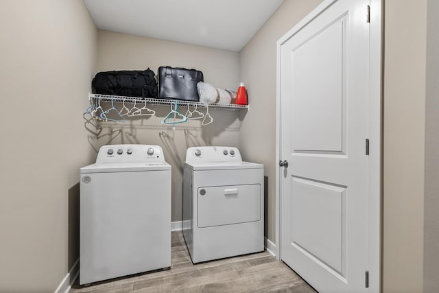 16386 Jaffna Pl, Lakeville, MN 55044 - laundry area with washer and clothes dryer and light wood-type flooring