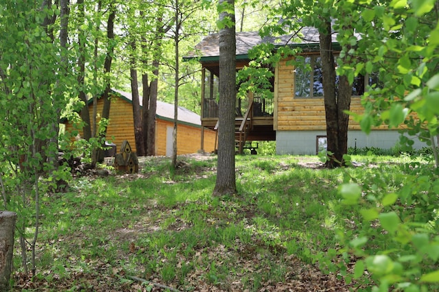 view of side of home featuring faux log siding