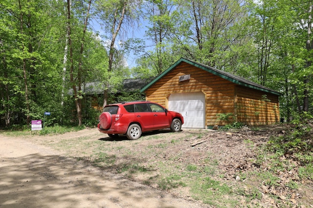 detached garage with dirt driveway