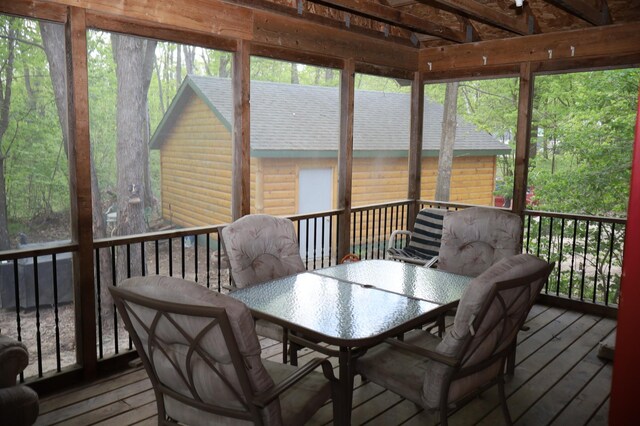 sunroom featuring outdoor dining area