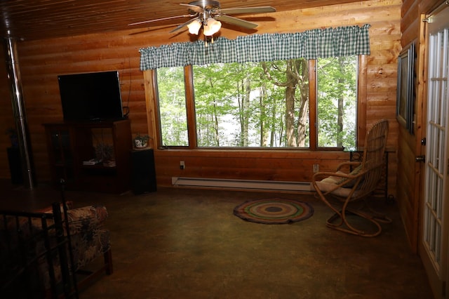 living area featuring a baseboard heating unit, a ceiling fan, and concrete flooring