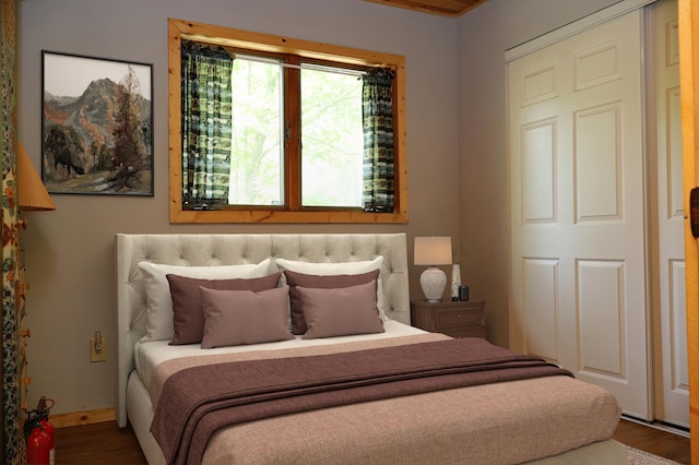 bedroom featuring wood finished floors and baseboards