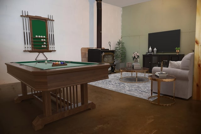 game room with a wood stove, finished concrete floors, and pool table