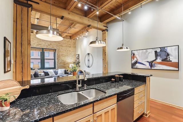 kitchen with wood ceiling with exposed beams, a sink, dishwasher, brick wall, and wood finished floors