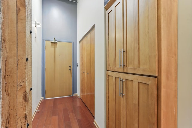 hall featuring wood finished floors and baseboards