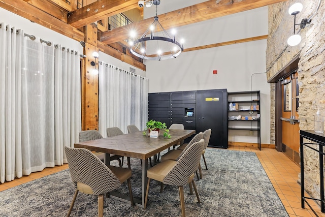 dining space featuring light tile patterned floors, beam ceiling, a chandelier, and mail area