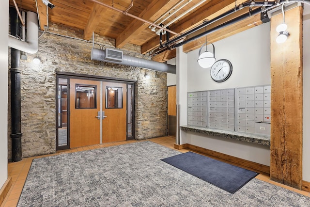 view of home's community featuring wooden ceiling with exposed beams and mail area