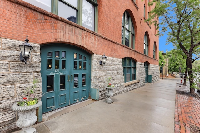 view of exterior entry featuring stone siding
