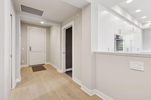 415 Indian Mound St Unit 302, Wayzata, MN 55391 - hallway featuring light wood finished floors, recessed lighting, and baseboards