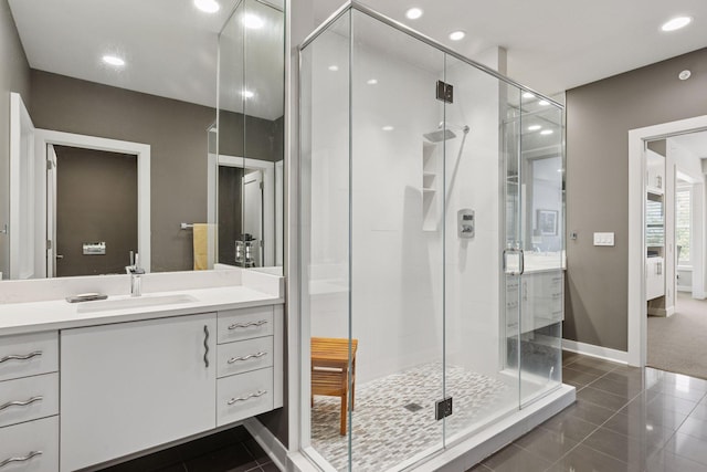 415 Indian Mound St Unit 302, Wayzata, MN 55391 - bathroom featuring a stall shower, vanity, baseboards, and recessed lighting